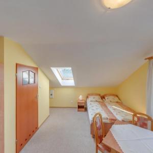 a attic bedroom with two beds and a skylight at O.S.W. WICIE in Wicie