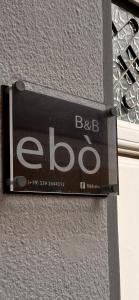 a sign on the side of a building at B&B Ebo' in Olbia