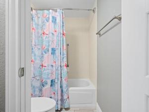 a bathroom with a toilet and a shower curtain at LR 108 - Starfish in Rockport