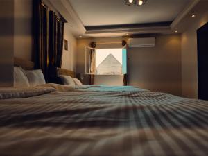 Voodi või voodid majutusasutuse Hur Pyramids Inn toas
