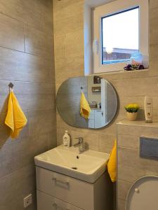 a bathroom with a sink and a mirror at SweetHome in Limbaži