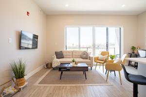 a living room with a couch and a table at Brand new! Stylish 2 Bedroom Condo in Chatham