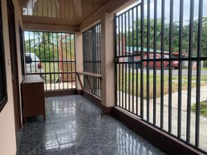 a screened in porch with a view of a driveway at Arenal Family House in Fortuna
