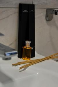 a bottle of oil and wooden sticks on a table at Apartmani Vila Ana in Gunjica +21 photos