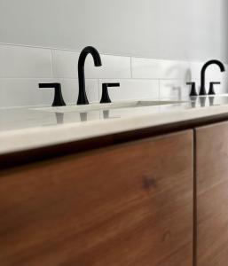 a counter with three sinks in a bathroom at The Hen Houses in Wildwood