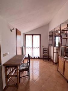 a kitchen with a table and chairs in a room at T V B - Vacanze Imperia in Imperia