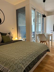 a bedroom with a bed and a table and a dining room at LA Studio in Maribor