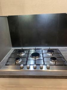 a stove top with four burners on top of it at Marilyn Apartment in Como