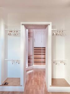 a walk in closet with white walls and wood floors at Casa Serendipia in La Asomada
