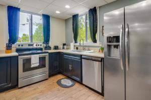 a kitchen with stainless steel appliances and blue cabinets at Charming Byrdstown Home with Fire Pit Near Lake in Byrdstown