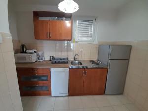 a kitchen with a refrigerator and a sink at App Goga in Umag +12 photos