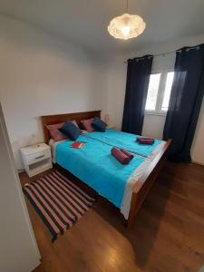 a bedroom with a large bed with blue sheets at App Goga in Umag