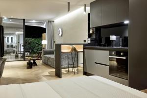a room with a kitchen and a living room at Icon Suite in Athens