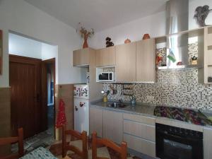 a kitchen with a refrigerator and a counter top at La casita de Poniente. Enjoy it! in Huelva