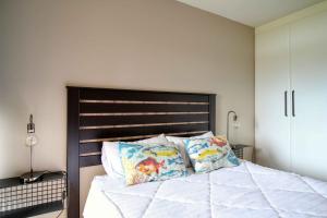 a bedroom with a large bed with two pillows at San Lameer Villa 2004 by Top Destinations Rentals in Southbroom +17 photos