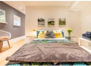 ein Schlafzimmer mit einem großen Bett mit bunten Kissen in der Unterkunft Modern Design Studio in Toronto
