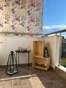 a room with a table and a wall with flowers at Casa Armonia in Nea Kallikrateia