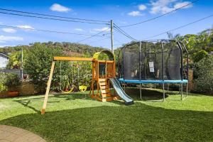 a playground with a slide and a swing set at Heated Pool, Beach Side Entetainer, Sleeps 18 in Umina