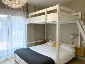 バイヨーナにあるsabaris -BAIONA a 200 metros de Playa Ladeiraのベッドルーム1室(二段ベッド1組、シャンデリア付)