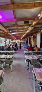 people sitting in an empty restaurant with tables and chairs at Mobile home in Boofzheim