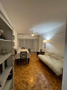 a bedroom with a bed and a table in a room at Depto cómodo en Pleno Centro Porteño in Buenos Aires