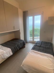 En eller flere senge i et værelse på Alba - Le Grotte Rooms & Apartments