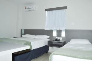 Postel nebo postele na pokoji v ubytování Pajuçara Hotel Express