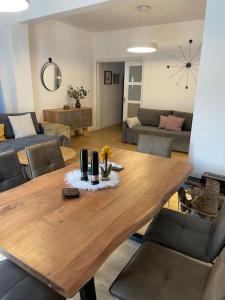 a wooden table in a living room with a couch at HOME OF OLYMPOS in Litochoro