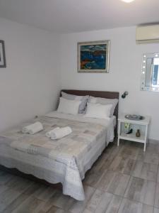 a bedroom with a bed with two towels on it at Apartments Ivica Split in Split