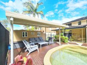 a backyard with a patio furniture and a swimming pool at Heated Pool, Beach Side Entetainer, Sleeps 18 in Umina