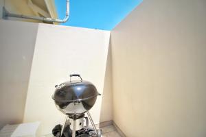 a pot on a stand next to a wall at Caribbean 1136 by Top Destinations Rentals in Port Edward