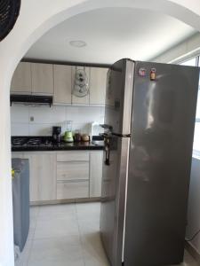 a kitchen with a stainless steel refrigerator in it at Alojamiento San Felipe in Cartagena de Indias