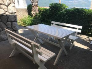 a picnic table and two benches sitting next to each other at Zo-Mi Apartments in Tivat