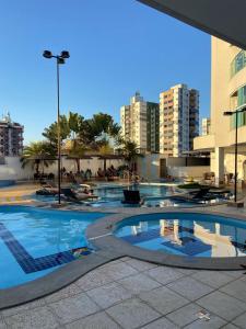 a large swimming pool in a city with buildings at Apartamento no Fiori Prime in Caldas Novas