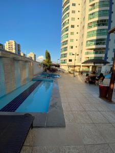 a swimming pool in a city with tall buildings at Apartamento no Fiori Prime in Caldas Novas