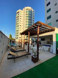a patio with tables and chairs and a pavilion at Apartamento no Fiori Prime in Caldas Novas