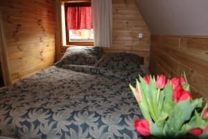 a bedroom with two beds and red tulips at Pensjonat Gościniec Szczyrk in Szczyrk
