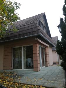 a house with a window and a roof at Siófoki nyaralóház in Siófok