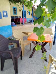 a patio with a table and chairs and a table at auberge yeswal aoulad yaakoube 