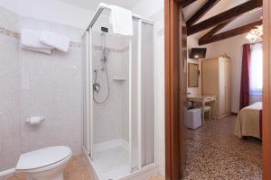 a bathroom with a shower and a toilet in a room at Alloggi SS Giovanni e Paolo in Venice