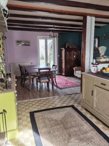 a kitchen with a table and a dining room at chambres d hotes L'agapé in Saint-Martial-sur-Isop