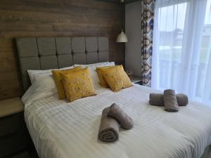 a large bed with pillows and blankets on it at Mawgan Pads Perranporth in Cubert +27 photos
