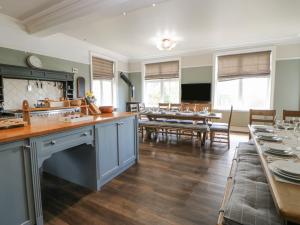 a large kitchen and dining room with tables and chairs at Heatherbrae in Barnard Castle
