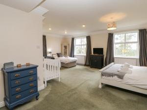 a bedroom with two beds and a blue dresser at Heatherbrae in Barnard Castle