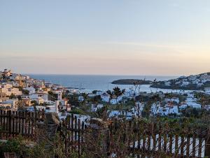 a view of a town with the ocean in the background at Zenios Andros-Cycladic house overlooking Batsi bay in Batsi