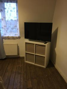 a flat screen tv sitting on top of a cabinet at Moore Crescent in Barking