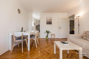 a living room with a table and a couch at Apartment house Silvia in Grižane