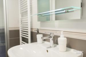 a bathroom with a sink and a mirror and a sink at Apartment house Silvia in Grižane +4 photos