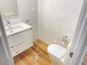 a bathroom with a white sink and a toilet at OH LA LIFE MAR in Portosin