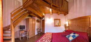 a bedroom with a bed and a wooden staircase at Park Hotel Bellavista in Calalzo